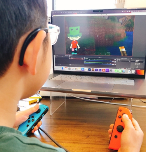 子どもがコントローラーを持ってSwitchのゲーム実況をしているところ